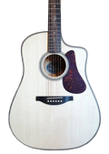 Acoustic guitar with a white finish and purple pickguard on a brown leather couch.