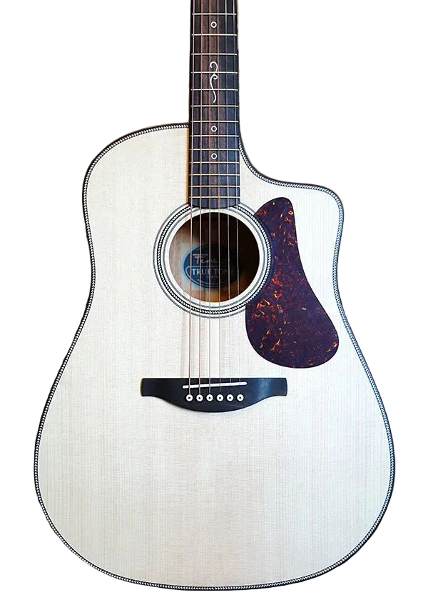 Acoustic guitar with a white finish and purple pickguard on a brown leather couch.