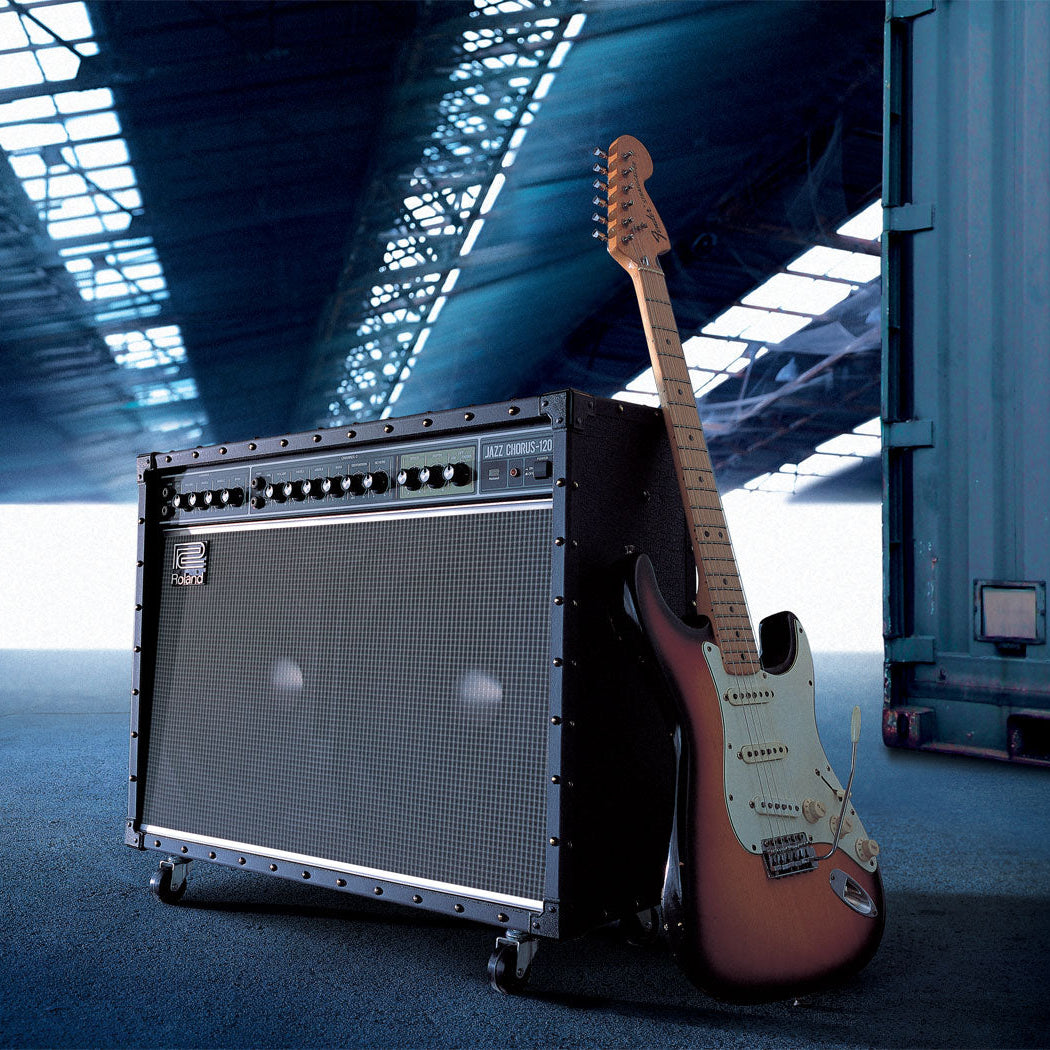 Guitar and amplifier in a warehouse setting